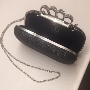 Black and silver knuckle clutch.